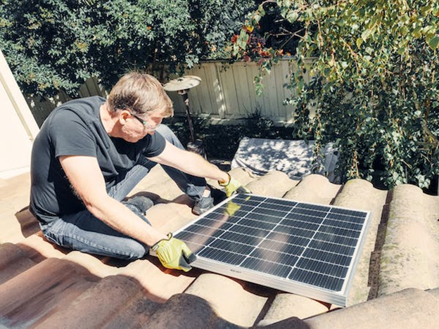 an installing a solar panel on a roof